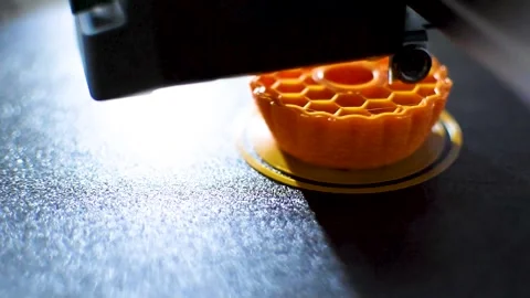 3d printer printing an object on the tray with pla filament, corn starch Stock Footage 308368665