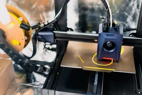 3d printer printing an object on the tray with filament Stock Photos