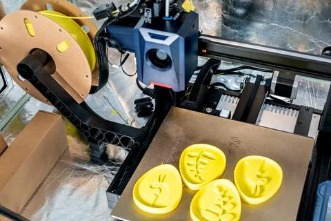 3d printer printing an object on the tray with filament Stock Photos