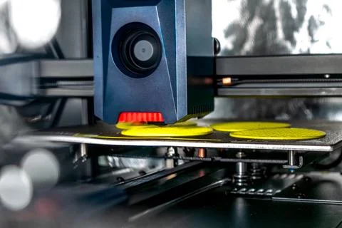 3d printer printing an object on the tray with filament Stock Photos
