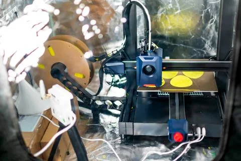 3d printer printing an object on the tray with filament Stock Photos