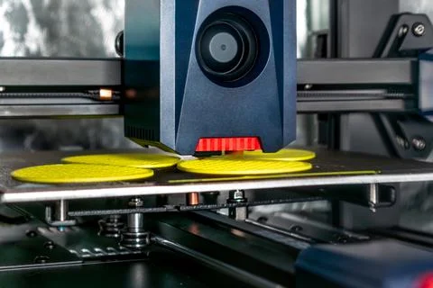 3d printer printing an object on the tray with filament Stock Photos