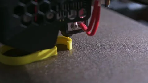 3D printer printing a part made of yellow plastic, close-up view Video stock 261831749