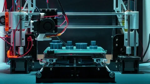 3d printer printing plastic objects gears and pulleys timelapse Stock Footage 74488882