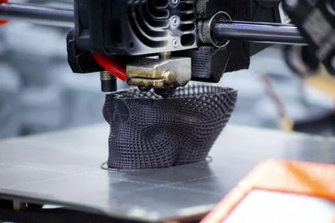 3D printer printing prototype human skull from molten plastic. Process creating Stock Photos