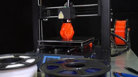 3D printer printing a red vase, Black background Stock Footage 104417303