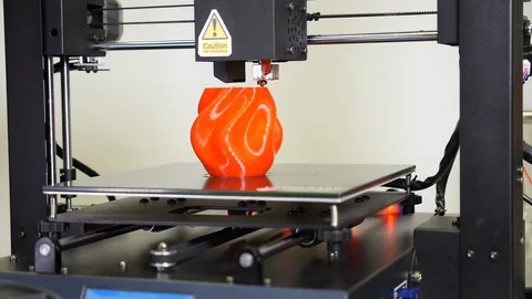 3D printer printing a red vase, White background Stock Footage 104418593