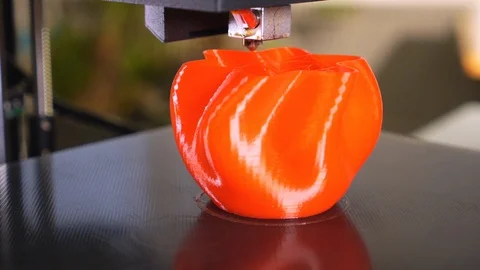 3D printer printing a red vase Stock Footage 104742545