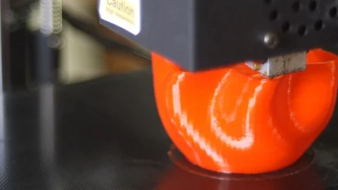 3D printer printing a red vase Stock Footage 104757374
