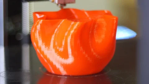 3D printer printing a red vase Stock Footage 104757467
