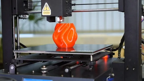 3D printer printing a red vase Stock Footage 104805164