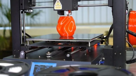 3D printer printing a red vase Stock Footage 104805179
