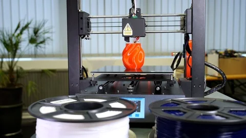 3D printer printing a red vase Stock Footage 104808651