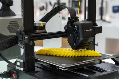 3D printer printing a yellow object model. Minsk, Belarus - March 16, 2025 Stock Photos