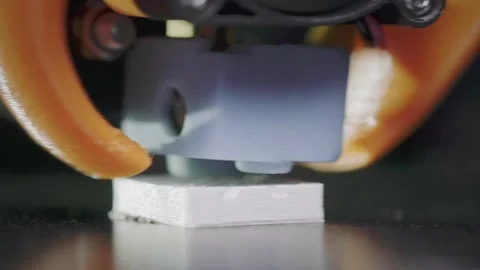 The 3D printer prints an abstract cube shape from white abs plastic. 3D printer Stock Footage 137960786