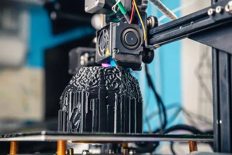 A 3D printer prints a black model. Technology at home Stock Photos