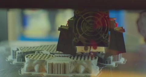 A 3D printer prints a complex plastic part. close-up. shallow depth of field. Stock Footage 171340619