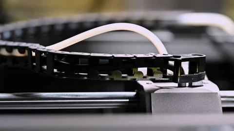 The 3D printer prints. Connecting cables and filament to the 3D printer head. Stock Footage 255202937