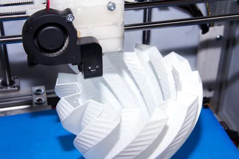 3D printer prints difficult shaped detail in 3D form plastic. Example of usin 스톡 사진