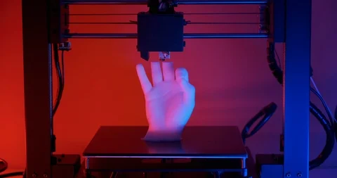 3D printer prints hands fingers ok sign made white plastic red blue neon light Stock Footage 126408999