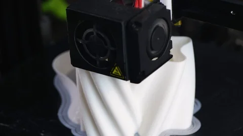 The 3D printer prints the model out of white plastic. 4K Stock Footage 124363546