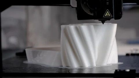 The 3D printer prints the model out of white plastic. 4K Stock Footage 124363569