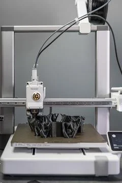 3D printer prints an object. The process of printing model on 3D printer. Model Stock Photos