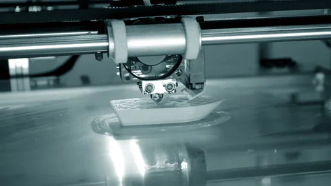 3d printer prints orange object close-up. Automatic three dimensional 3D printer Stock Footage 153058610