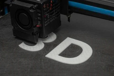 3D printer prints the word 3D with white filament PLA Stock Photos