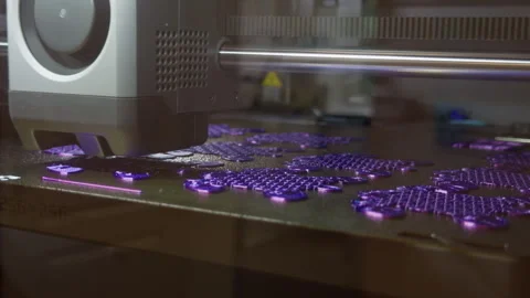 3D printer producing purple plastic parts on build plate with close up Stock-Footage 346558772