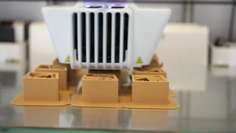 A 3D printer producing small models Stock Footage 135821256