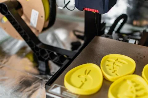 3d printer with some objects on the tray printed with pla filament Stock Photos