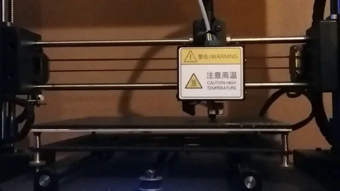 3d printer turned on and moving. Horizontal camera angle focused on print Stock Footage 117408163