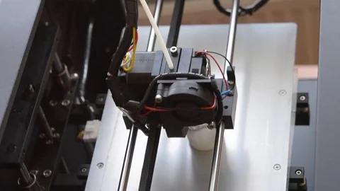 3d printer in work and prints the form of molten plastic close-up. Top view Stock Footage 76840345