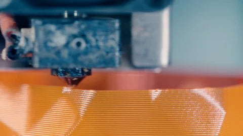 3D printer working at 3d printing lab. Orange plastic layers are getting 3D Stock Footage 124203320