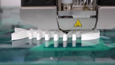 3D printer working and creating an object from the hot molten plastic Stock Footage