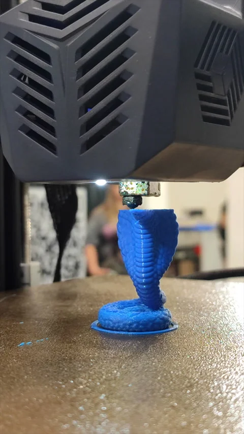 3D printer working close-up printer prints model molten blue plastic Vertical Stock Footage 287123040