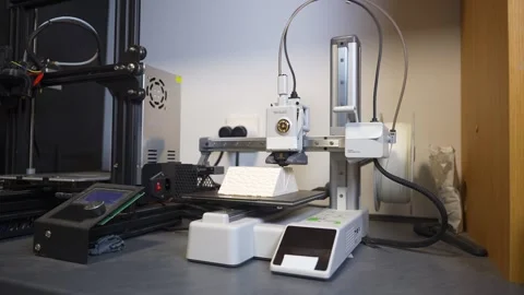 3D printer working on a high-precision model with plastic material for printing Stock Footage 328258653