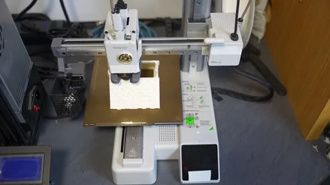 3D printer working on a high-precision model with plastic material for printing Stock Footage 328258706