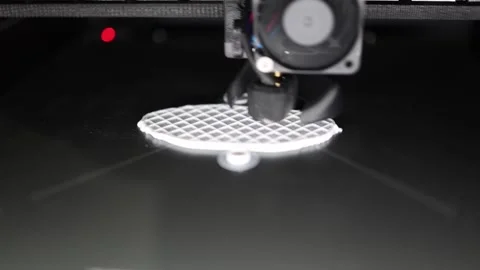 3D printer working slowly on a round plastic base with a precise grid pattern fu Stock Footage 311047499
