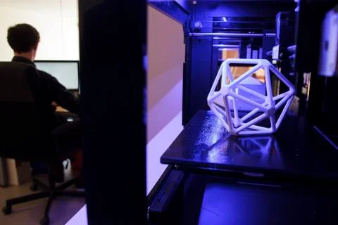 3D printers and man working with a computer Stock Photos