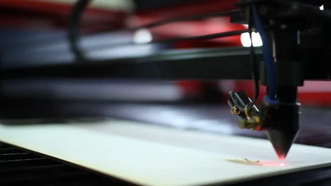 A 3D printer's laser beam burns through a drawing on a wooden Board. Stock Footage 134898491