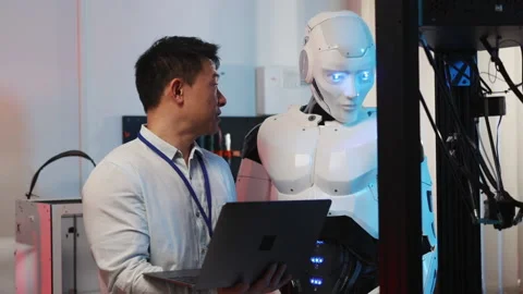 3D printing. Asian developer engineer teaching commands to AI cybenetic robot Stock Footage 153744469
