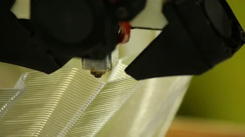 A 3d printing head/nozzle precisely lays down the next layer of a build Stock Footage 89773104