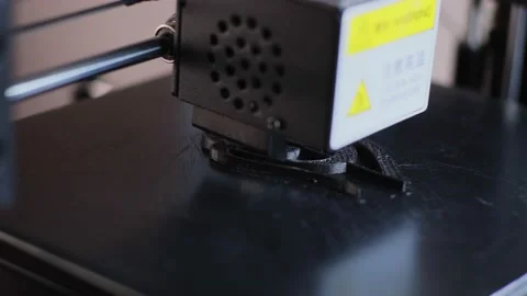 3d printing machine makes black detail applying hot plastic Stock Footage 140838426