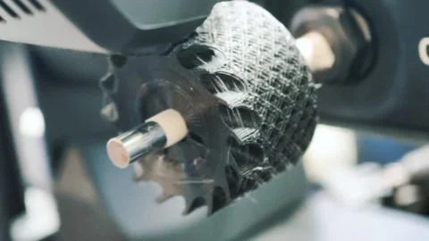 3D printing process creating intricate plastic parts in a workshop setting Stock Footage 315420450