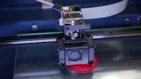 3D printing process on red plastic filament using desktop 3D printer closeup Video stock 312157599