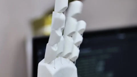 3D printing white robotic prosthesis hand in a technology exhibition Stock Footage 322028264
