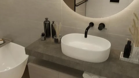 3d-render. Bathroom with a round mirror and black faucets, in a modern style. Stock Footage 237870153