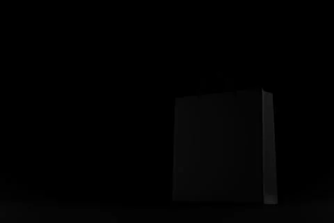 3d render black shop bag on black background. 3d rendering black shopping bag on Illustrazione stock